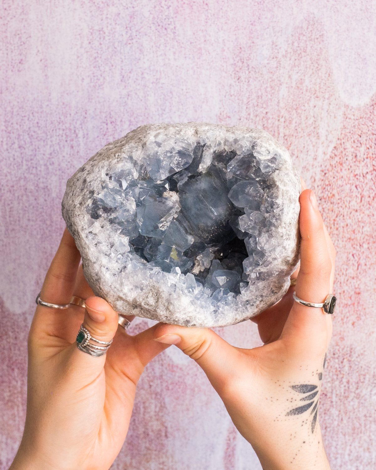 A blue celestite crystal, also known as celestine, on a white background with the words The Ultimate Guide to Celestite written in bold font above it