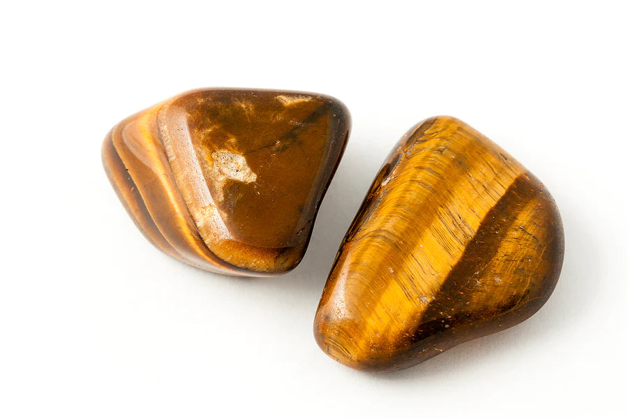 Image of a golden-brown Tiger's Eye gemstone, with a unique chatoyancy, symbolizing the grounding, protection and balance in life